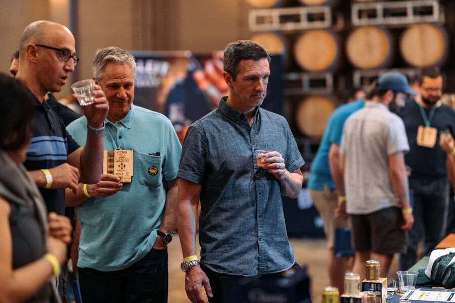 A guest pouring a sample at a whisk(e)y brand's booth at the festival