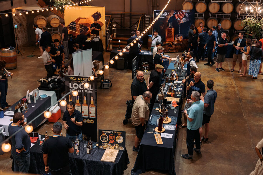 An overhead view of attendees mingling and sampling whisk(e)y on the festival floor