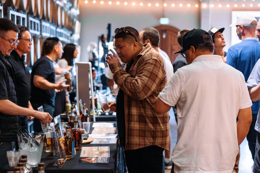 A couple posing together at a whiskey brand's festival booth