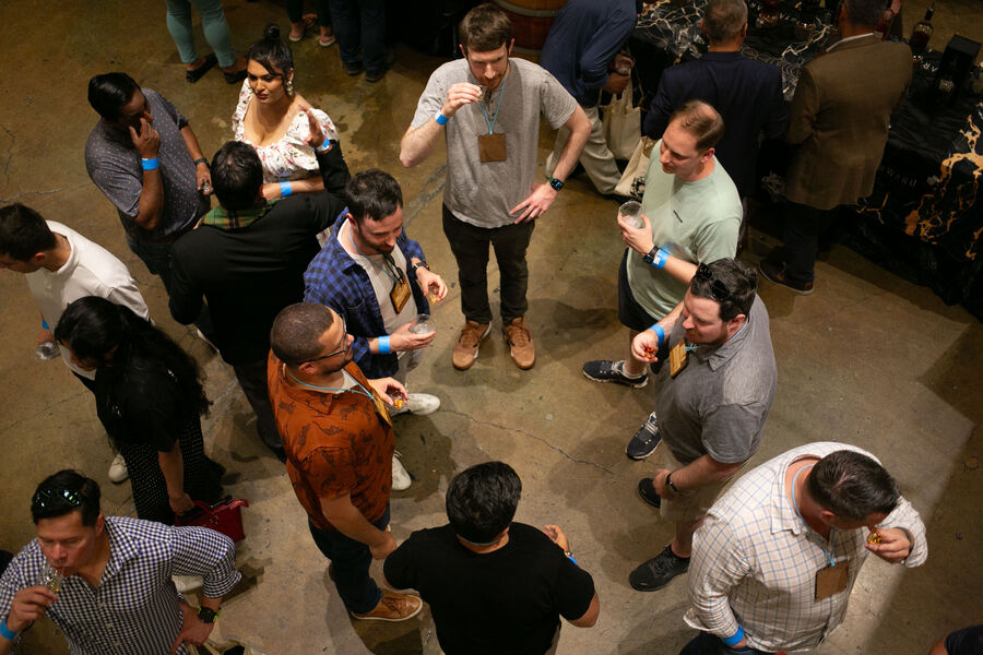 Attendees sampling whisk(e)y at a distillery's festival booth