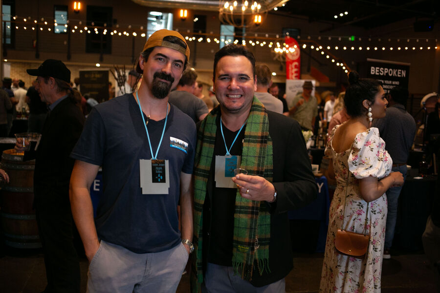 Two attendees enjoying whisk(e)y pours together at the festival