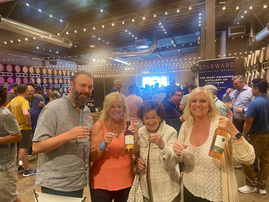 A group of friends enjoying whisk(e)y samples together at the festival